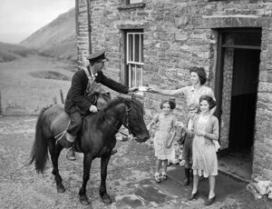 Delivering post in 1955 - Copyright Geoff Charles - National Library of Wales