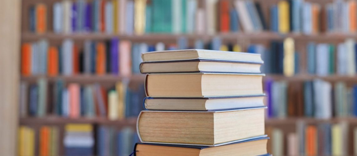 Stack,Of,Books,Against,The,Background,Of,Library,,Stack,Of